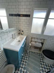 a bathroom with a sink and a toilet at Maison de pêcheur in Perros-Guirec