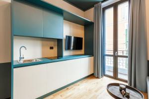 a kitchen with blue and white cabinets and a window at Palazzo Quantum 1 in Milan +184 photos