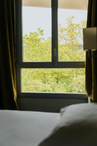 Postel nebo postele na pokoji v ubytování Hôtel d'Orsay Grand Matabiau