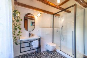 a bathroom with a shower and a sink and a toilet at Casa Oliva by Kompas Villas in Čepljani +17 photos
