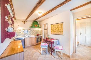 a kitchen with a table and chairs in it at Casa Oliva by Kompas Villas in Čepljani
