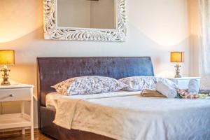a bedroom with a bed with a mirror on the wall at Casa Oliva by Kompas Villas in Čepljani