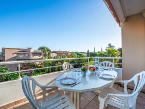 a table and chairs on a balcony with a view at Apartment Le Domaine de la Baie-4 by Interhome in Cavalaire-sur-Mer