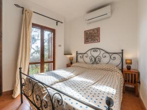 a bedroom with a bed and a window at Villa La Conchiglia by Interhome in Villasimius