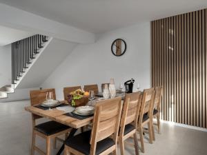 a dining room with a wooden table and chairs at Holiday Home Holiday House Arni by Interhome in Delnice