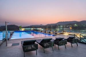 a swimming pool on the roof of a building at Radisson Resort Khopoli in Khopoli