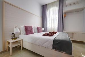 Katil atau katil-katil dalam bilik di Kirxa Rooms and Suites