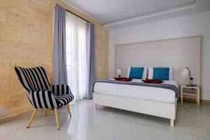 Katil atau katil-katil dalam bilik di Kirxa Rooms and Suites