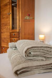 a pile of towels sitting on top of a bed at Villa Luz in Lajares
