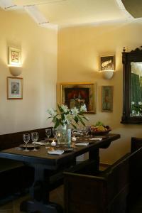 a dining room with a table with wine glasses at Maritsas Hotel & Suites in Portariá