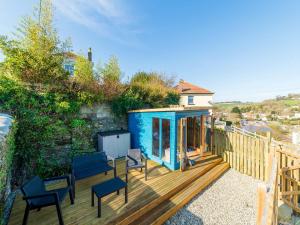 a blue tiny house on a wooden deck at Holiday Home Chy An Mor by Interhome in Mevagissey