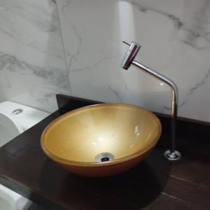 a wooden bowl sink on a counter in a bathroom at Green House Torres in Torres
