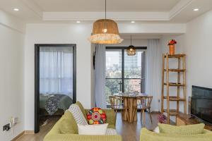 a living room with a couch and chairs and a table at Marina Bay One & Two Bedroom Apartment, Swimming pool, gym, workspace ,Wonderiss Homes Westland Living in Nairobi