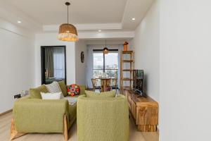 a living room with a couch and chairs and a table at Marina Bay One & Two Bedroom Apartment, Swimming pool, gym, workspace ,Wonderiss Homes Westland Living in Nairobi