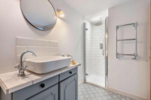 a white bathroom with a sink and a shower at Saltwater Stunning Holiday Terraced House Milford on Sea Lymington Sleeps 6 in Milford on Sea