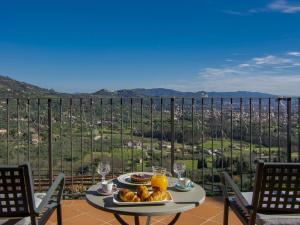 a table with a plate of food on a balcony at Villa Panorama by Interhome in Colle di Buggiano