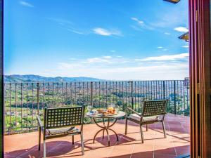 a balcony with a table and chairs and a view at Villa Panorama by Interhome in Colle di Buggiano