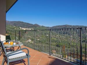a balcony with a table and a view of the mountains at Villa Panorama by Interhome in Colle di Buggiano