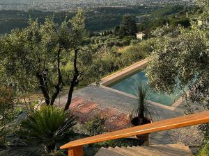 a swimming pool in a garden with trees at Villa Panorama by Interhome in Colle di Buggiano +37 photos