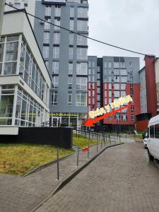 a parking lot in front of a large building at "M&D ApartmentsLviv", Loft complex Great Britain in Lviv