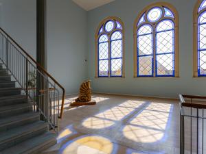 a room with a staircase and stained glass windows at Altstadt-Studios Neuer Markt in Stralsund +90 photos