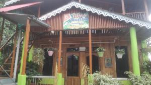 a building with a sign on the front of it at Yuma Homestay in Mangpu