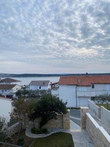 arial view of buildings and a body of water at Apartmani Begic 1 i 2 in Barbat na Rabu