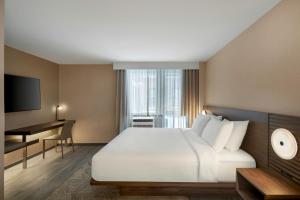 a hotel room with a large bed and a desk at AC Hotel by Marriott Old Montreal in Montréal +50 photos