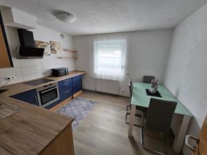 a small kitchen with a table and a counter top at Ferienwohnung in Friedrichshafen in FDH