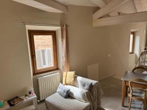 a living room with a chair and a window at santarelli in Fermo +47 photos