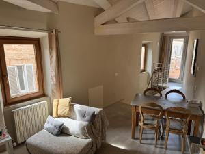 a living room with a table and a couch at santarelli in Fermo