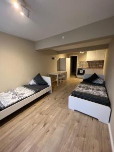 a room with two beds and a table in it at Moon Monteur Apartment in Rodenbach