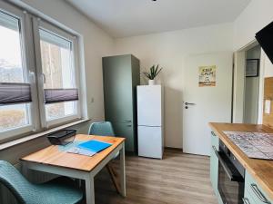 a small kitchen with a desk and a refrigerator at Ferienwohnung Weins in Treis-Karden