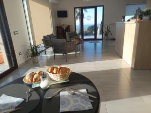 a living room with a table with a tray of bread at b&b TENUTE LAZZARINO in Sciacca