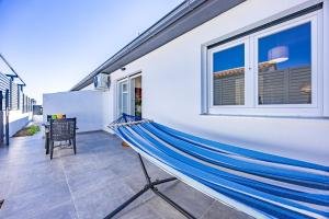 a hammock on the balcony of a house at Barbariga Beach Paradise 1 in Peroj