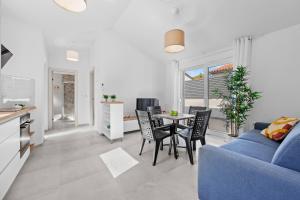 a living room with a blue couch and a table at Barbariga Beach Paradise 1 in Peroj +15 photos