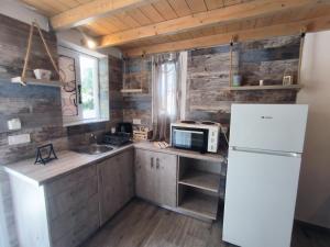 a kitchen with a white refrigerator and a sink at Aussie Studios in Argostoli