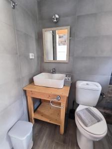 a bathroom with a sink and a toilet and a mirror at Aussie Studios in Argostoli +9 photos