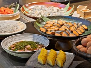 a table with plates of food and bowls of food at Millennium Mitsui Garden Hotel Tokyo - Ginza in Tokyo