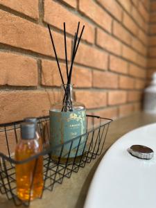 a vase with sticks in it sitting on a shelf at Chalé Jacarandá - Hidro - Wifi e mais in Sapucaí-Mirim
