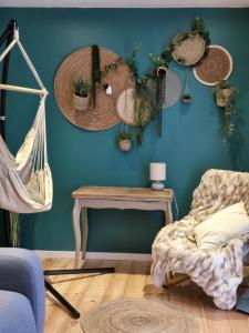 a room with a blue wall with potted plants at La petite champêtre in Bouconville-Vauclair