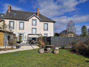 a large white house with a fence in the yard at La petite champêtre in Bouconville-Vauclair