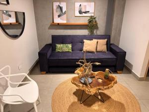 a living room with a blue couch and a table at Parallelo Loft Salento P1 in Salento
