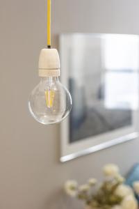 a glass light bulb hanging from a wall at Casa Leon in Mantova