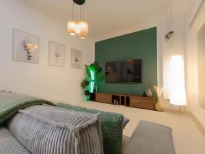 a living room with a bed and a flat screen tv at SA Exklusives Stadtapartment mit 3 SZ in Warburg