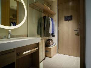 a bathroom with a sink and a mirror at Millennium Mitsui Garden Hotel Tokyo - Ginza in Tokyo
