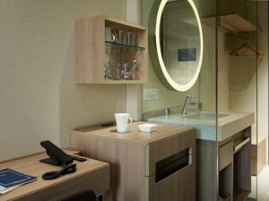 a bathroom with a sink and a mirror at Millennium Mitsui Garden Hotel Tokyo - Ginza in Tokyo