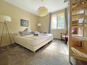 a bedroom with a bed and a chair and a window at Maison rénovée avec piscine privée, 3 chambres à Calès - FR-1-824-8 in Calès +16 photos