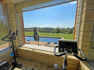 a gym with a window with a view of a pool at Maison rénovée avec piscine privée, 3 chambres à Calès - FR-1-824-8 in Calès