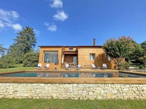 a house with a swimming pool and a stone wall at Maison rénovée avec piscine privée, 3 chambres à Calès - FR-1-824-8 in Calès